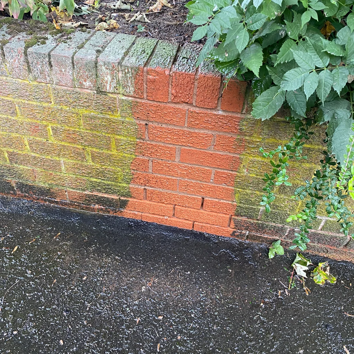 A freshly cleaned strip showing the original brick colour beneath surface growth